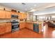 Modern kitchen featuring stainless steel appliances, wood cabinets, and granite countertops at 2799 Alnwick Ct, Henderson, NV 89044