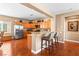 Eat-in kitchen with wood cabinets, granite countertops, stainless steel appliances, and a breakfast bar with seating at 2799 Alnwick Ct, Henderson, NV 89044