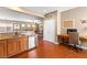 Open concept kitchen featuring stainless steel appliances, hardwood floors, and a view into the living space at 2799 Alnwick Ct, Henderson, NV 89044