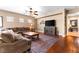 Well-decorated living room features wood-look flooring, a ceiling fan, and a cozy sectional at 2799 Alnwick Ct, Henderson, NV 89044