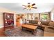 Inviting living room with hardwood floors, a ceiling fan, comfortable seating, and access to the kitchen area at 2799 Alnwick Ct, Henderson, NV 89044