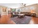 Spacious living room with wood-look flooring, a large rug, and comfortable seating at 2799 Alnwick Ct, Henderson, NV 89044