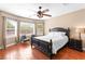 Inviting main bedroom with hardwood floors, ceiling fan, natural light, and neutral décor at 2799 Alnwick Ct, Henderson, NV 89044