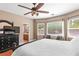 Spacious main bedroom featuring a ceiling fan, large windows, and an attached bathroom at 2799 Alnwick Ct, Henderson, NV 89044