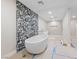Modern bathroom featuring an accent wall with stand alone tub and walk-in shower at 3075 Santa Margarita St, Las Vegas, NV 89146