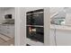 Modern kitchen with Wolf double ovens and white cabinetry at 3075 Santa Margarita St, Las Vegas, NV 89146