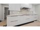 Bright kitchen features white cabinets, marble backsplash, and stainless steel appliances at 3075 Santa Margarita St, Las Vegas, NV 89146