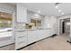 Bright kitchen features white cabinets, stainless steel sink, and view of the backyard pool at 3075 Santa Margarita St, Las Vegas, NV 89146