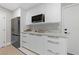Bright kitchenette features white cabinets, stainless steel appliances, and marble counters at 3075 Santa Margarita St, Las Vegas, NV 89146