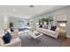 Staged living room features neutral furniture, recessed lighting, and large window at 3075 Santa Margarita St, Las Vegas, NV 89146