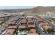 Expansive aerial view of a desert community showcasing red-tiled roofs, carports, a pool, and well-maintained landscaping at 3360 Cactus Shadow St # 203, Las Vegas, NV 89129