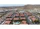 Expansive aerial view of a desert community showcasing red-tiled roofs, carports, a pool, and well-maintained landscaping at 3360 Cactus Shadow St # 203, Las Vegas, NV 89129