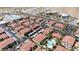 Aerial view of the community featuring red roofs, multiple parking spots, and a community pool at 3360 Cactus Shadow St # 203, Las Vegas, NV 89129