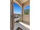 View of the front balcony featuring stucco walls and a view of the parking spots and greenery nearby at 3360 Cactus Shadow St # 203, Las Vegas, NV 89129