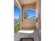 View of the front balcony featuring stucco walls and a view of the parking spots and greenery nearby at 3360 Cactus Shadow St # 203, Las Vegas, NV 89129