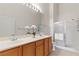 Bathroom boasts double sinks, a large mirror with decorative lighting, and a glass-enclosed shower at 3360 Cactus Shadow St # 203, Las Vegas, NV 89129