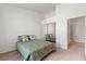 Bedroom features neutral carpet, mirrored closet doors, and an adjacent bathroom at 3360 Cactus Shadow St # 203, Las Vegas, NV 89129