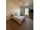 A bedroom with a queen bed, neutral walls, ceiling fan, and natural light from a window at 3360 Cactus Shadow St # 203, Las Vegas, NV 89129