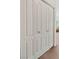 Hallway closet doors with view to carpet and partially-seen furniture at 3360 Cactus Shadow St # 203, Las Vegas, NV 89129