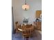 Inviting dining area featuring a round wooden table with chairs and a decorative lighting fixture at 3360 Cactus Shadow St # 203, Las Vegas, NV 89129