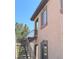Tan condo exterior with a brown metal staircase and stucco facade under a bright blue sky at 3360 Cactus Shadow St # 203, Las Vegas, NV 89129