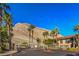 Community features a gated entry with palm trees and desert landscaping, nestled beneath a mountain backdrop at 3360 Cactus Shadow St # 203, Las Vegas, NV 89129