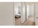 Hallway shot with carpet, ceiling fan, and view into a bedroom with neutral decor at 3360 Cactus Shadow St # 203, Las Vegas, NV 89129