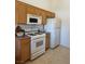 Efficient kitchen layout with ample cabinet space, white appliances, and a gas range at 3360 Cactus Shadow St # 203, Las Vegas, NV 89129