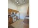 Functional kitchen with light wood cabinets, white appliances, and ample countertop space at 3360 Cactus Shadow St # 203, Las Vegas, NV 89129