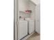Laundry area features a stacked washer and dryer with a shelf and open door at 3360 Cactus Shadow St # 203, Las Vegas, NV 89129