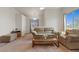 Inviting living room with plush seating, soft carpet, and bright natural light from large windows at 3360 Cactus Shadow St # 203, Las Vegas, NV 89129