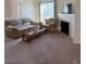 A comfortable living room featuring carpet, a sofa, and a fireplace for relaxation and warmth at 3360 Cactus Shadow St # 203, Las Vegas, NV 89129