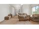 Cozy living room with comfortable seating, soft carpet, and natural light from the window at 3360 Cactus Shadow St # 203, Las Vegas, NV 89129
