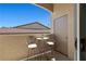 Patio features a small dining table, wrought iron chairs, and building view at 3360 Cactus Shadow St # 203, Las Vegas, NV 89129