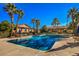 Community offers a large outdoor pool with ample seating, mature landscaping, and clear skies at 3360 Cactus Shadow St # 203, Las Vegas, NV 89129