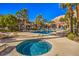 Community amenities feature a pool and jacuzzi surrounded by lounge chairs and manicured landscaping at 3360 Cactus Shadow St # 203, Las Vegas, NV 89129
