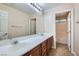 Well-lit bathroom featuring a double vanity and a doorway leading to the shower and toilet at 368 Misty Moonlight St, Henderson, NV 89015