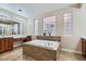 Luxurious bathroom with large soaking tub, tiled surround, and custom vanity at 368 Misty Moonlight St, Henderson, NV 89015