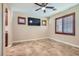 Cozy bonus room with tile flooring, a ceiling fan, and a mounted TV at 368 Misty Moonlight St, Henderson, NV 89015