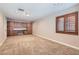 Large bonus room with plush carpet, a window with shutters, and built-in cabinets with a desk at 368 Misty Moonlight St, Henderson, NV 89015