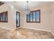 Dining room featuring chandelier, tiled floor, and wood trimmed windows and door at 368 Misty Moonlight St, Henderson, NV 89015