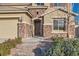 Close up of a home's entrance with a brick walkway and stone veneer details at 368 Misty Moonlight St, Henderson, NV 89015