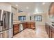Modern kitchen with stainless steel appliances, granite countertops, and wood cabinetry at 368 Misty Moonlight St, Henderson, NV 89015