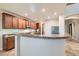 Spacious kitchen features wooden cabinets, granite counters, stainless steel appliances, and a breakfast bar at 368 Misty Moonlight St, Henderson, NV 89015