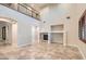 Open concept living room with fireplace, tile flooring, and natural light at 368 Misty Moonlight St, Henderson, NV 89015