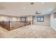 Spacious loft area with a ceiling fan, neutral carpet, wood trim and natural light from the windows at 368 Misty Moonlight St, Henderson, NV 89015