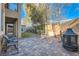 Backyard brick patio with seating, outdoor fireplace, lush lawn and string lights at 368 Misty Moonlight St, Henderson, NV 89015