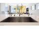 Contemporary kitchen with sleek stainless steel sink and view to the living space and outside views beyond at 3726 Las Vegas Blvd # 2410, Las Vegas, NV 89158