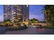 Grand entrance to the Four Seasons Residences with lush landscaping and modern architecture at 400 Rock Peak Dr # 2301, Henderson, NV 89012