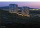 Luxury high-rise towers stand majestically against a backdrop of mountains and city lights at dusk at 400 Rock Peak Dr # 2301, Henderson, NV 89012